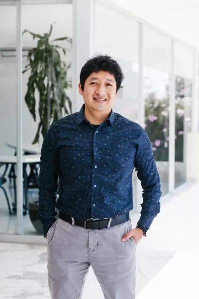 Latin man portrait looking to camera outside office in Mexico city